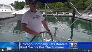 Video still of a sailtime member piloting a boat on cbs chicago news