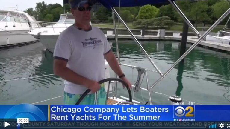 Video still of a SailTime member piloting a boat on CBS Chicago News