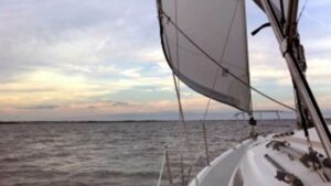 Sailboat in the foreground of a photo of the horizon