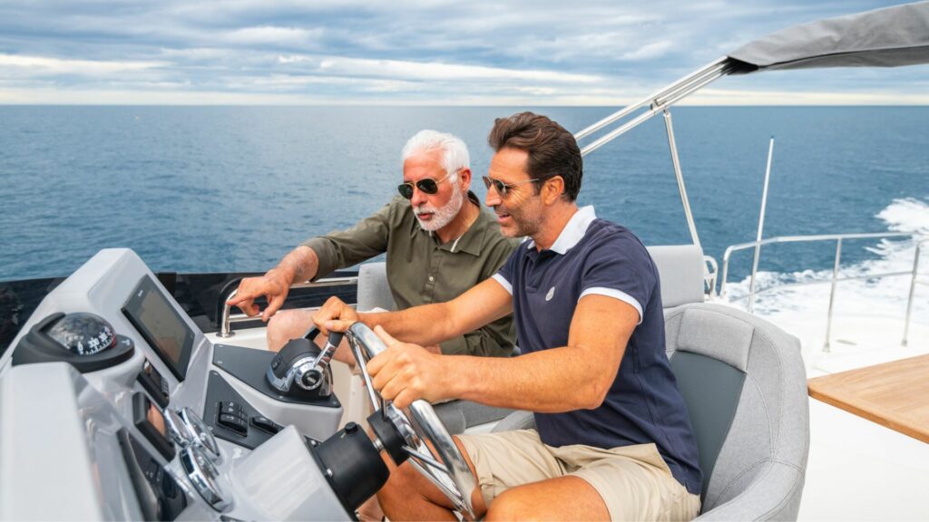 Two men at the helm of a beneteau swift trawler 41.