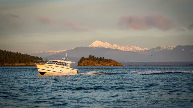 Nimbus boat on the water near Anacortes with islands and mountains in the background