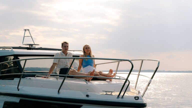 Two peopple lounging on the sun pad of an Acquador 250 HT.